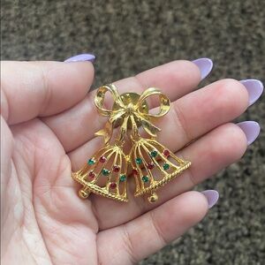 Elegant Gold Bell Pin with Red and Green Accents